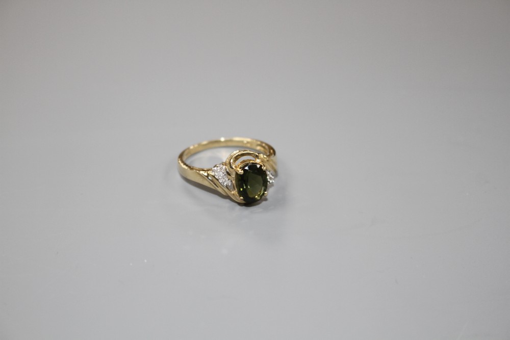 A modern 9ct gold, olive green paste and diamond set dress ring, size S, gross weight 3.2 grams.